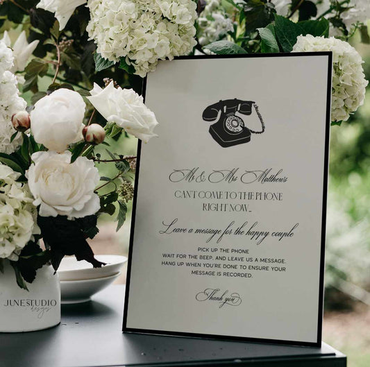 Wedding reception telephone sign with vintage phone illustration and floral decorations.