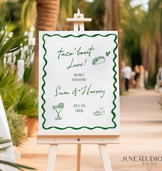 hand drawn Taco bout love welcome sign with green text on white foam board tropical restaurant background
