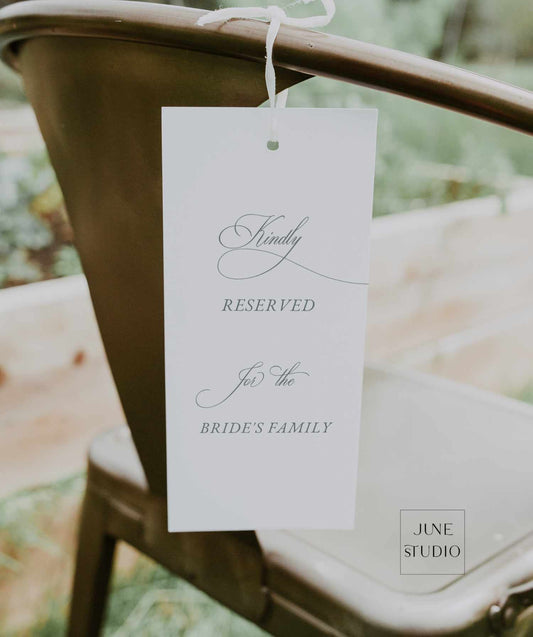 Reserved sign for the bride's family on a chair with elegant script font