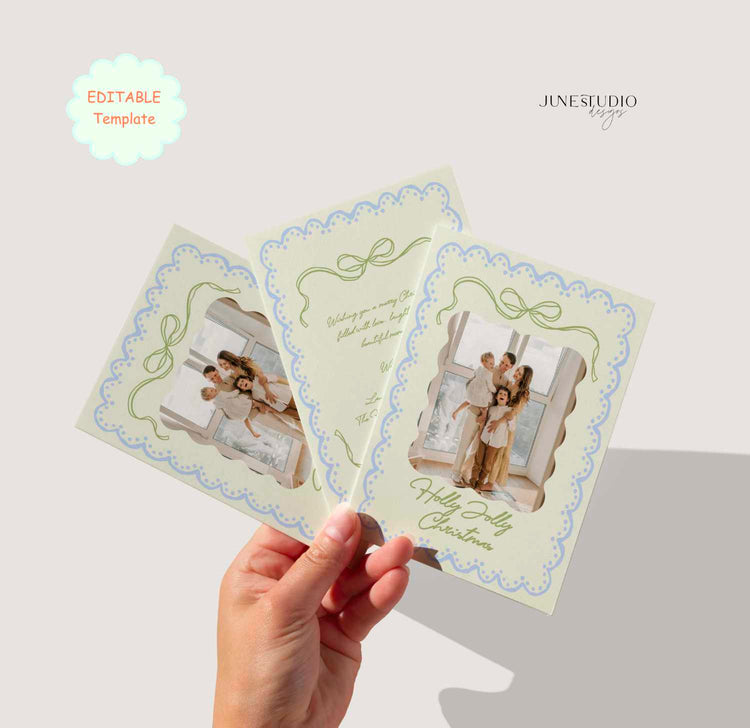 A hand holds three Christmas greeting card templates with a vintage photo frame design, set against a light beige background with 'JINES STUDIO design' and 'Editable Template' text overlays.